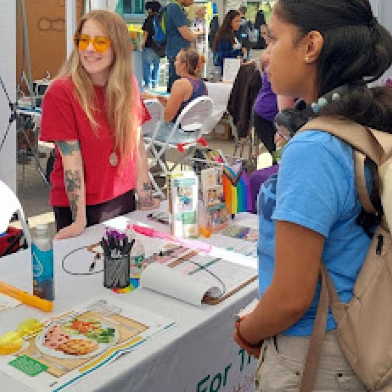 Student visiting tables during Service & Internship Fair