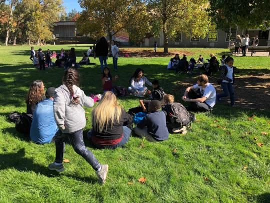 a group playing duck duck goose 