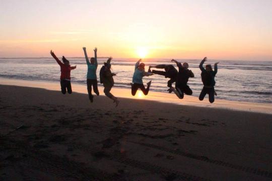 Jumping on the beach at sunset