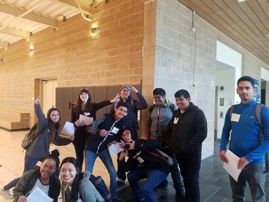 Students pose for a silly photo in the doorway of the basketball court