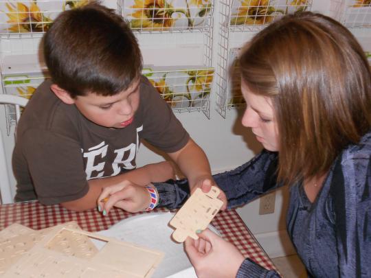 Max Breal and SSU service-learning Anna Gavin work together on a puzzle.