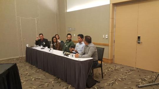 A panel of people sitting at a table