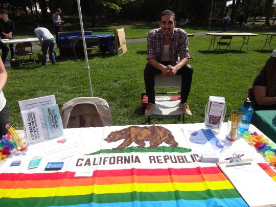 Javier Rivera, Outreach Coordinator tabling for the Service and Internship Fair.